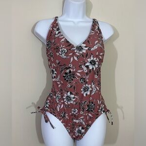Kona Sol sz med swimsuit tan with a little pink undertone and a floral print
